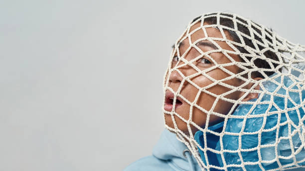 istock Worried man with knitted bag of garbage on head 1462622600