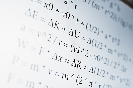 Computer screen displaying a large number of physics and math equations, suitable for use as a science background or illustration.