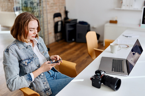 Young beautiful woman working from the office