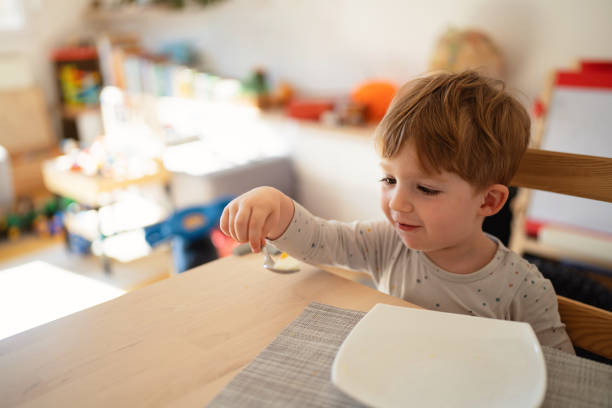istock Caucasian toddler boy playing with spoon 1462635306