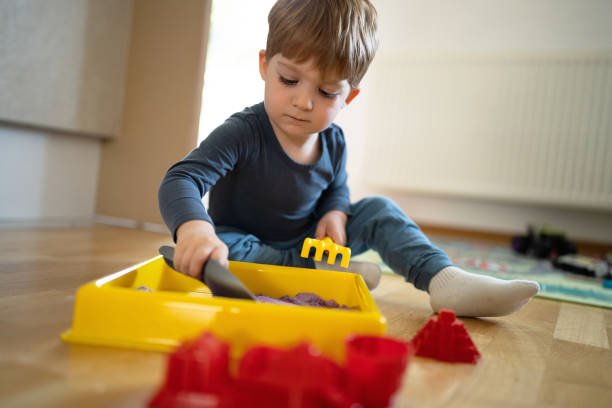 istock Toddler boy playing with hydrophobic sand 1462636518