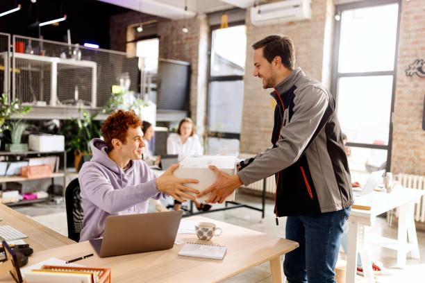 istock Courier making a delivery to a businessman at work 1462638316