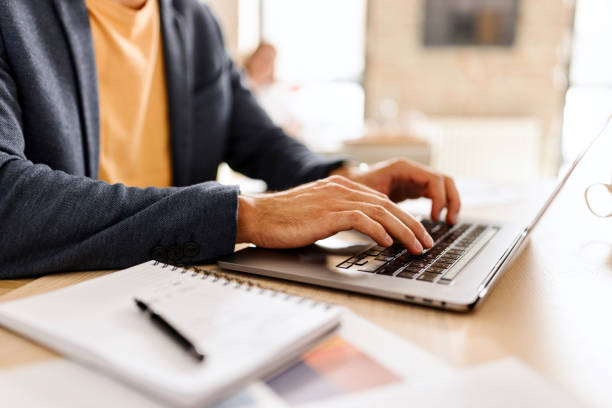 istock Close up of man working on his laptop 1462640437