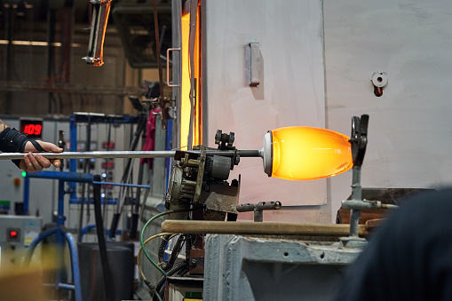 Blowing glass from raw material at glassworks
