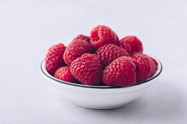 istock Raspberry. Fresh organic juicy raspberries in white bowl close-up 1462646370