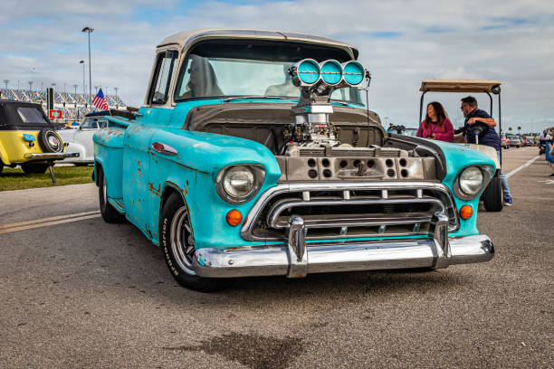 Customized 1957 Chevrolet 3100 Stepside Pickup Daytona Beach, FL - November 26, 2022: Wide angle front corner view of a Customizoed 1957 Chevrolet 3100 Stepside Pickup at a local car show. 1950s racing car stock pictures, royalty-free photos & images