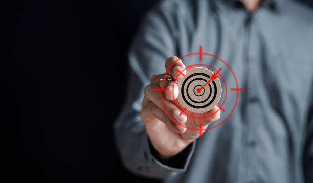 istock Businessman holding wood block aiming target icon for planning development leadership and customer target group, objective to success concept. 1462654540