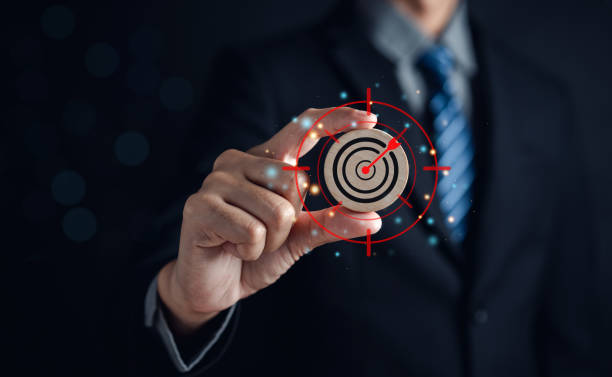 istock Businessman holding wood block aiming target icon for planning development leadership and customer target group, objective to success concept. 1462654542