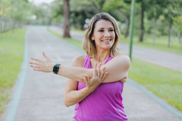 istock Portrait of a woman doing arm stretches 1462659111