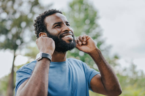 istock Man putting on bluetooth headphones 1462659289