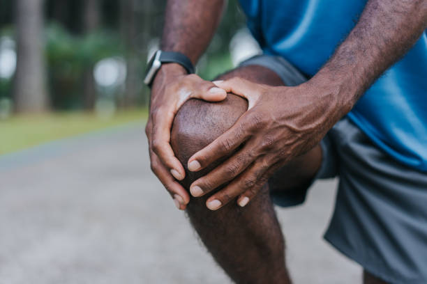 With hands on knee pain