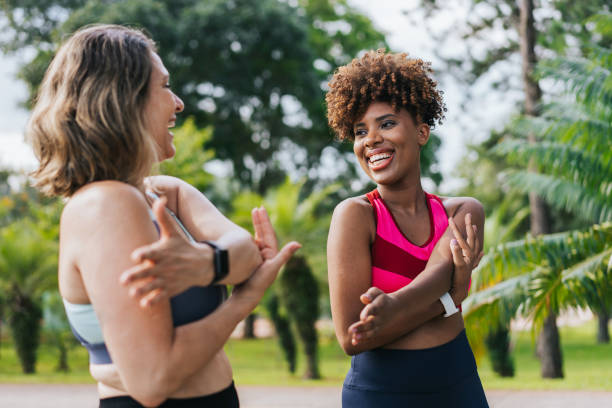 istock Two female friends warming up for training outside 1462659490