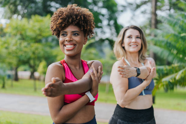 istock Two female friends warming up for training outside 1462659536