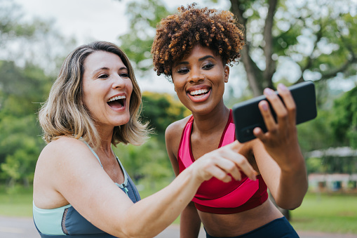Two female friends taking selfie during exercise break