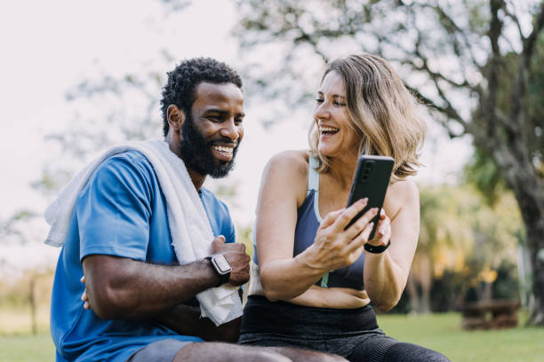 istock Couple taking a break from exercising to look at their smartphone 1462659693
