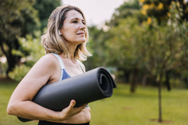 istock Mature woman going to practice physical exercise with exercise mat 1462659718