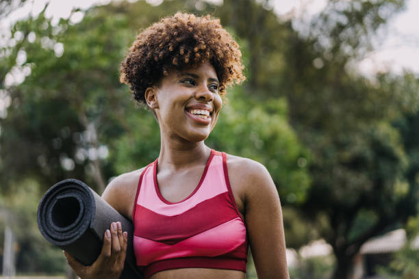 istock Young woman going to exercise holding exercise mat 1462659726