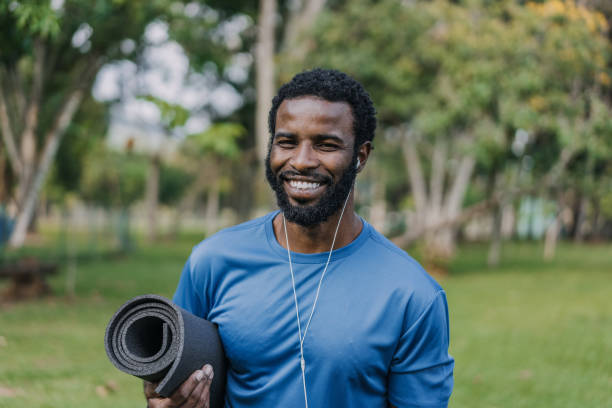 istock Portrait of a man going to exercise holding exercise mat looking at camera and smiling 1462659730