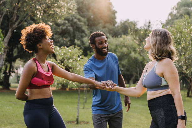 istock Group of active mature friends in park stacking hands after workout 1462659745