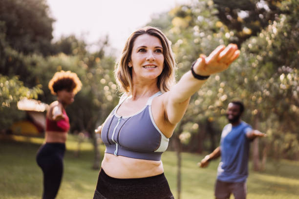 istock Small group of people exercising outdoors 1462659754