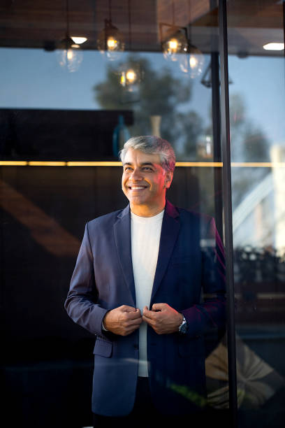 istock Businessman standing at office seen through glass window 1462659764