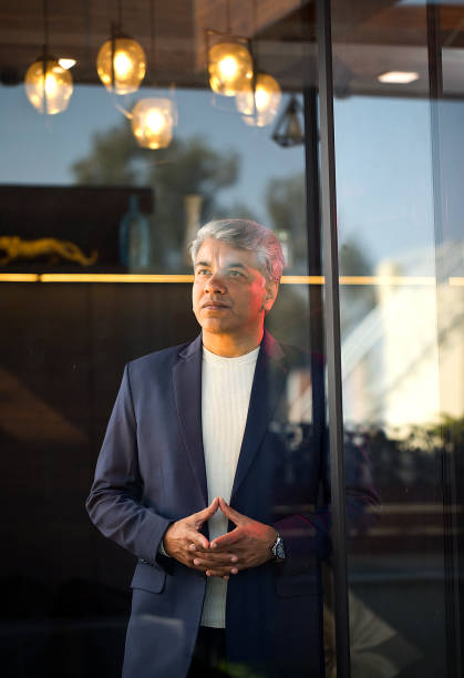 istock Thoughtful businessman looking away with his hands clasped at office 1462659794