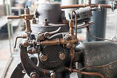 istock Fragment of an old-fashioned engine. Bolts, valves, tubes, wires and other parts on the engine. 1462661438