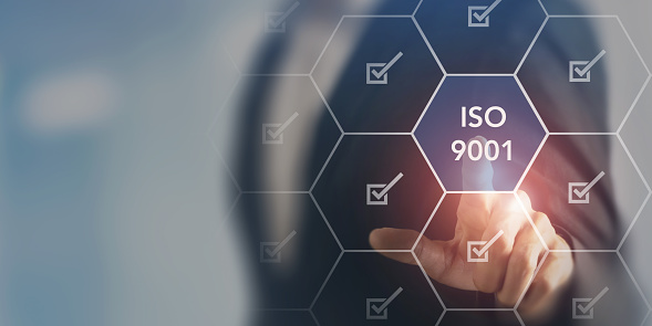 ISO 9001 concept. The international standard, the requirements for a quality management system. Providing products and services quality to customer, regulatory requirements, continual improvement.