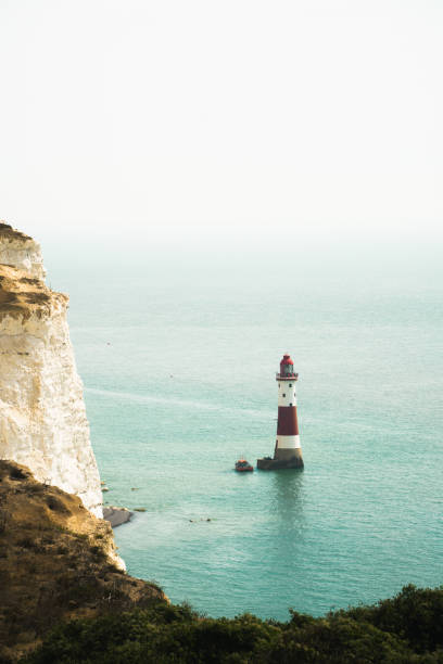 White cliffs in England at the ocean with a light house