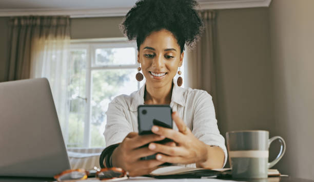 istock Phone, smile and business woman doing remote work and mobile networking planning with tech. Laptop of a young person on social media and internet streaming video in a home on a web app happy 1462664013
