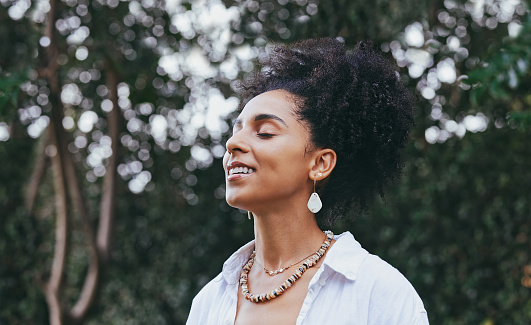 Black woman, breathing and smile for fresh air in nature, travel or calm peace outdoors. Happy African American female smiling in happiness taking deep breath for zen, health or spiritual wellness