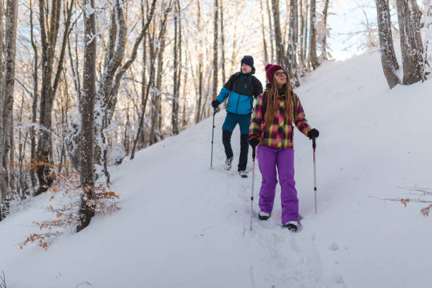 istock Two young hikers climbing down a snowy mountain footpath 1462664286