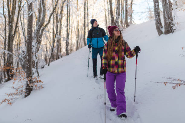 istock Two young hikers climbing down a snowy mountain footpath 1462664308