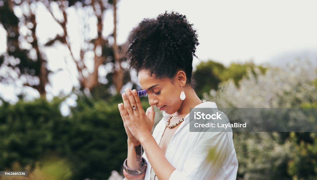 Spiritual, woman pray and nature with zen yoga and meditation for peace and wellness. Mindfulness exercise, prayer and chakra energy health of a person with balance and calm worship for healing Praying Stock Photo