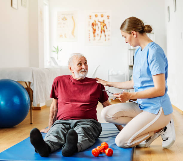 istock nurse doctor senior care exercise physical therapy exercising help assistence retirement home physiotherapy strech band clinic therapist elderly man 1462665530