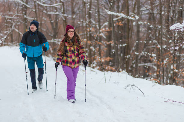 istock Two handsome young hikers climbing up a snowy mountain during winter 1462665967