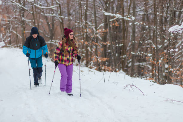 istock Two handsome young hikers climbing up a snowy mountain during winter 1462665969
