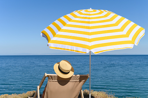 Beautiful beach with empty beach seat and umbrellas at small town of Monterosso in the Cinque Terre Park in Italy stock photo