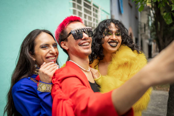 Taking a selfie Group of friends using mobile phone to take selfie LGBT stock pictures, royalty-free photos & images