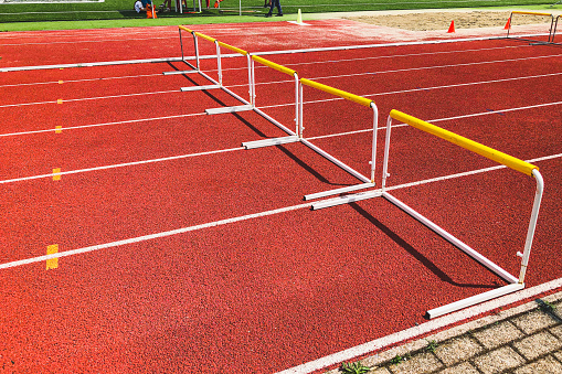 Yellow hurdles on a red running track