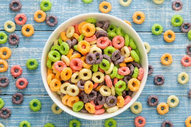 istock Colored breakfast cereals on a blue wooden background, top view, close up. 1462671299