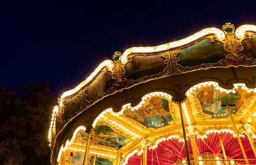 A merry-go-round ride, all lit up at night, in Copenhagen, Denmark