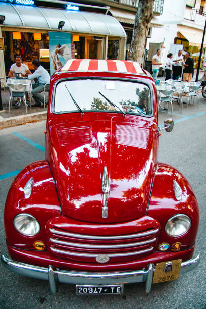 Vintage car at an outdoor event. An italian red Fiat 500 Topolino convertible at an event for car collectors. Giulianova, Teramo, Italy - July 31, 2012: Vintage cars at an outdoor event in Giulianova, Teramo. An italian red Fiat 500 Topolino convertible at an event for car collectors. Amaranth Topolino. Topolino amaranto fiat 500 topolino stock pictures, royalty-free photos & images