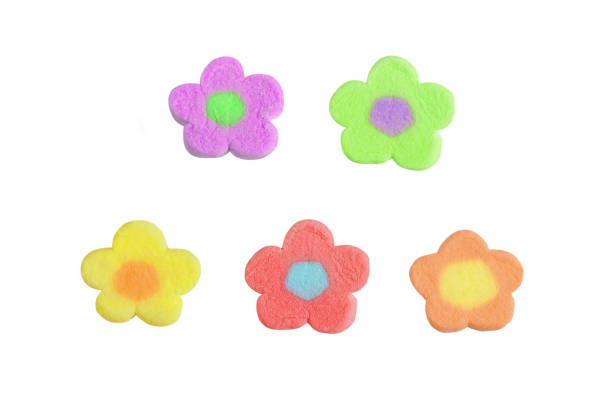 istock Pastel tone multi-colored flower shaped marshmallow candies isolated on white background 1462673953