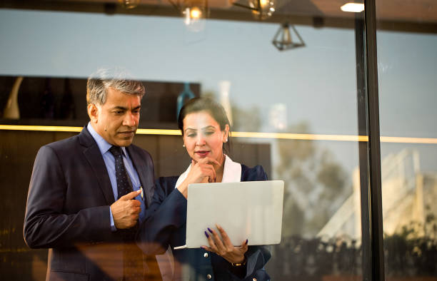 istock Business people discussing using laptop at office 1462674573