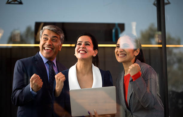 istock Business people celebrating success using laptop at office 1462675485