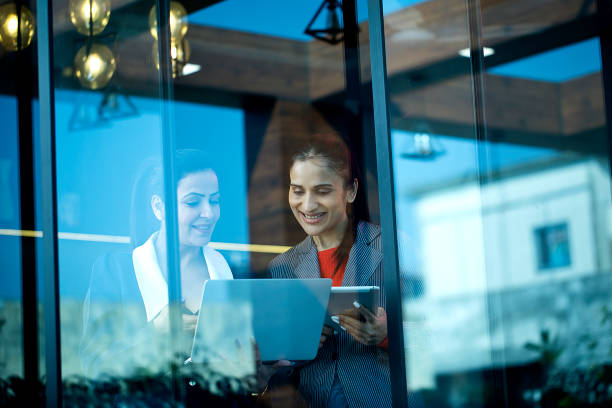 istock Two businesswomen discussing using laptop and digital tablet at office 1462677018