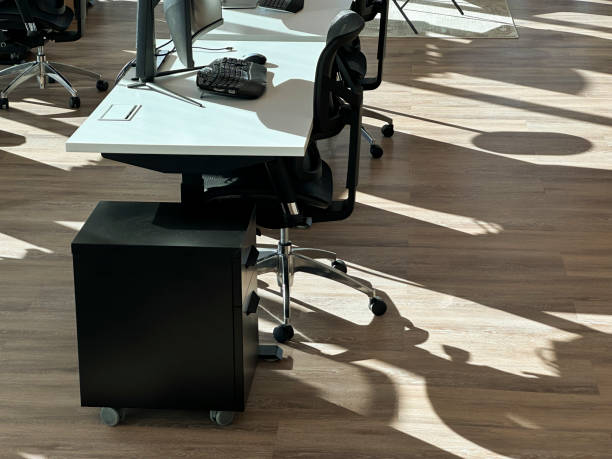 istock Desk with with computers in a modern office at sunrise 1462683393