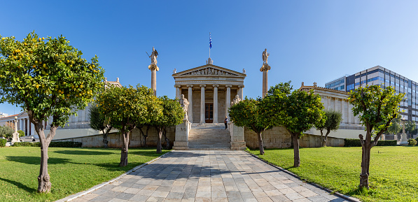 A picture of the Academy of Athens and the nearby orange trees.