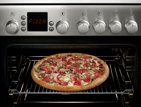 Close up photograph of freshly baked pizza pie in an household oven